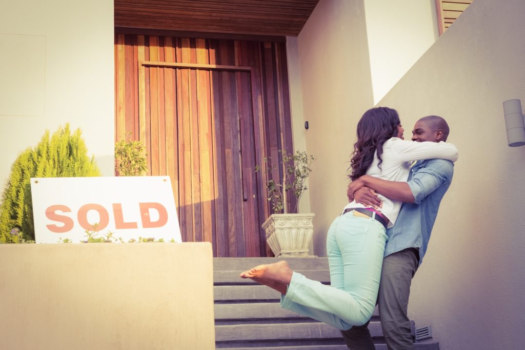 Happy african american couple after buying new house